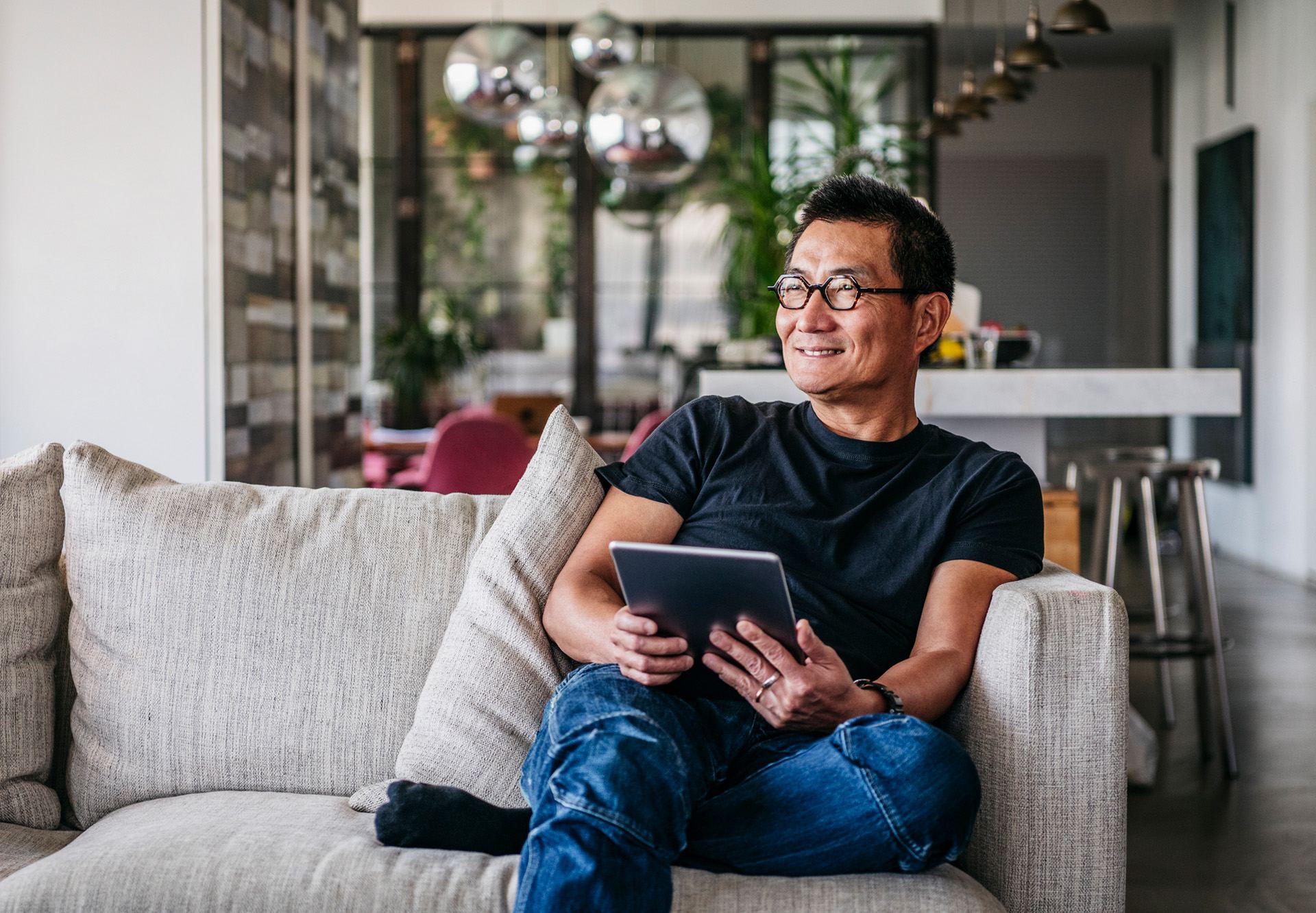 sitting on couch with tablet
