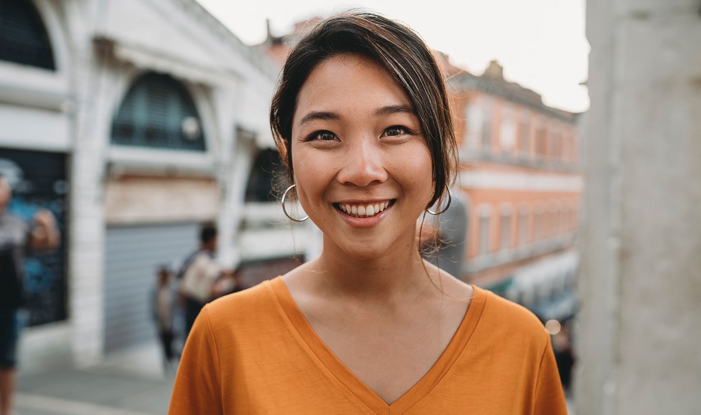 smiling in orange v-neck