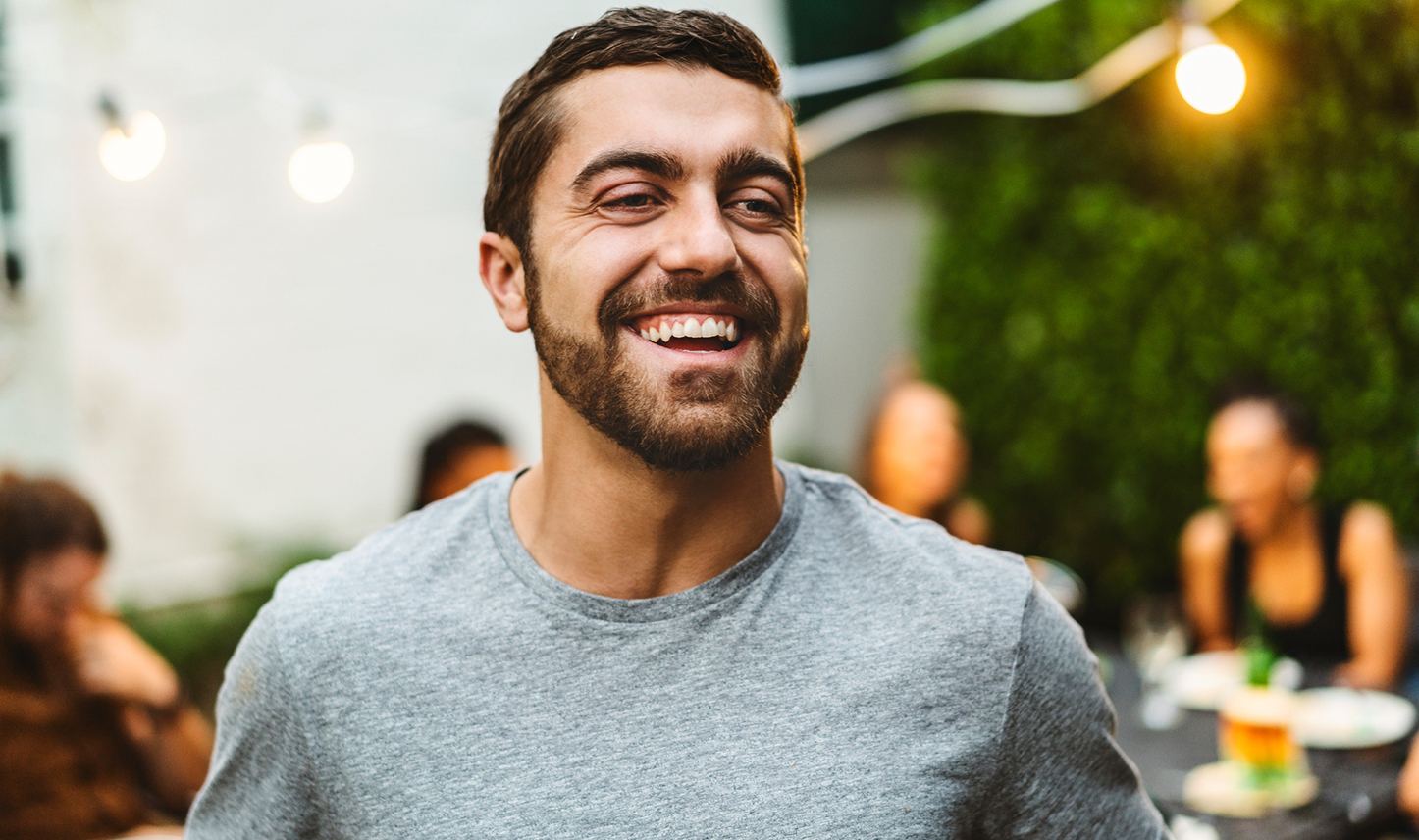 smiling at outdoor dinner party